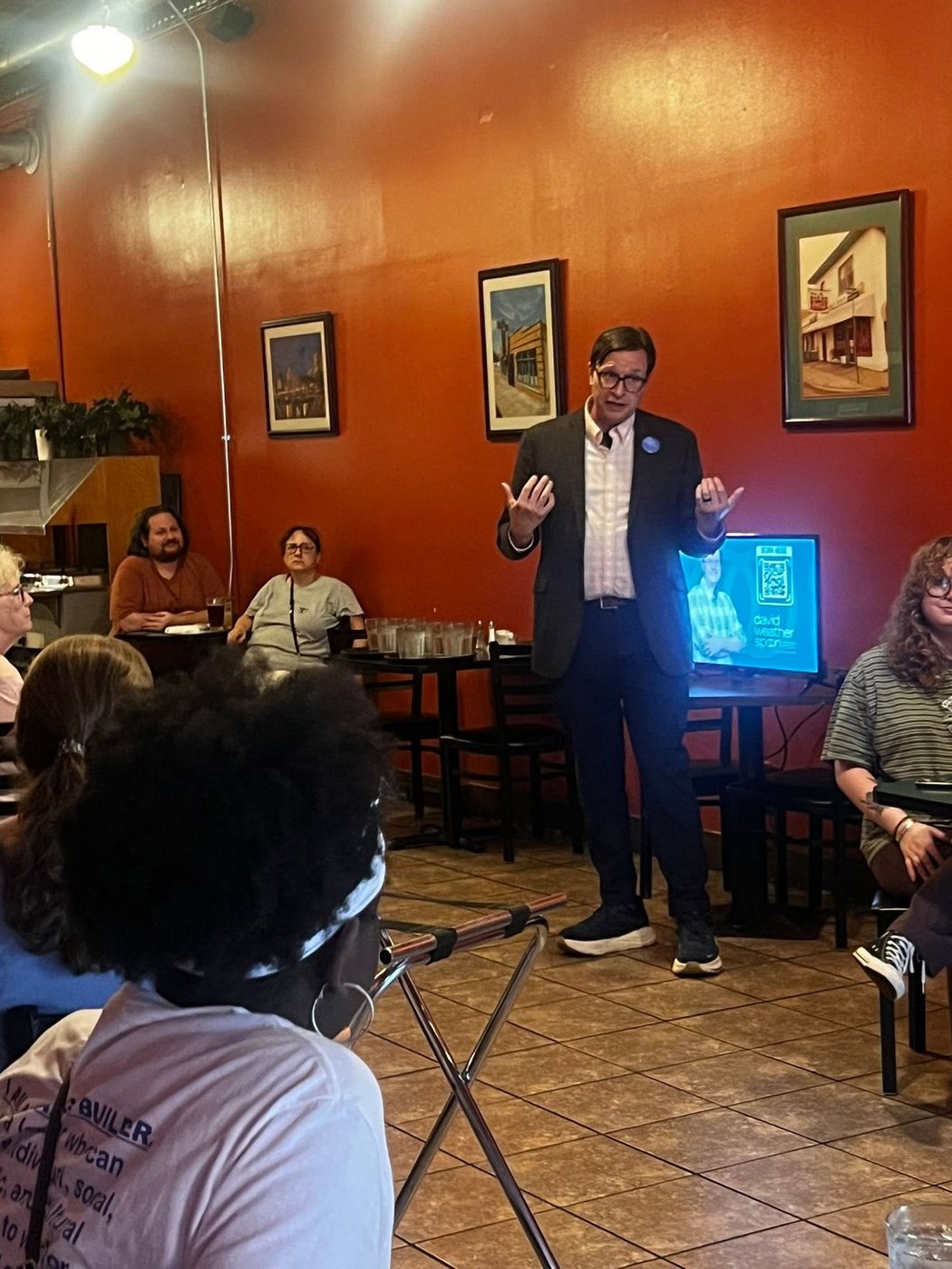 A speaker taking questions from members during a club program.