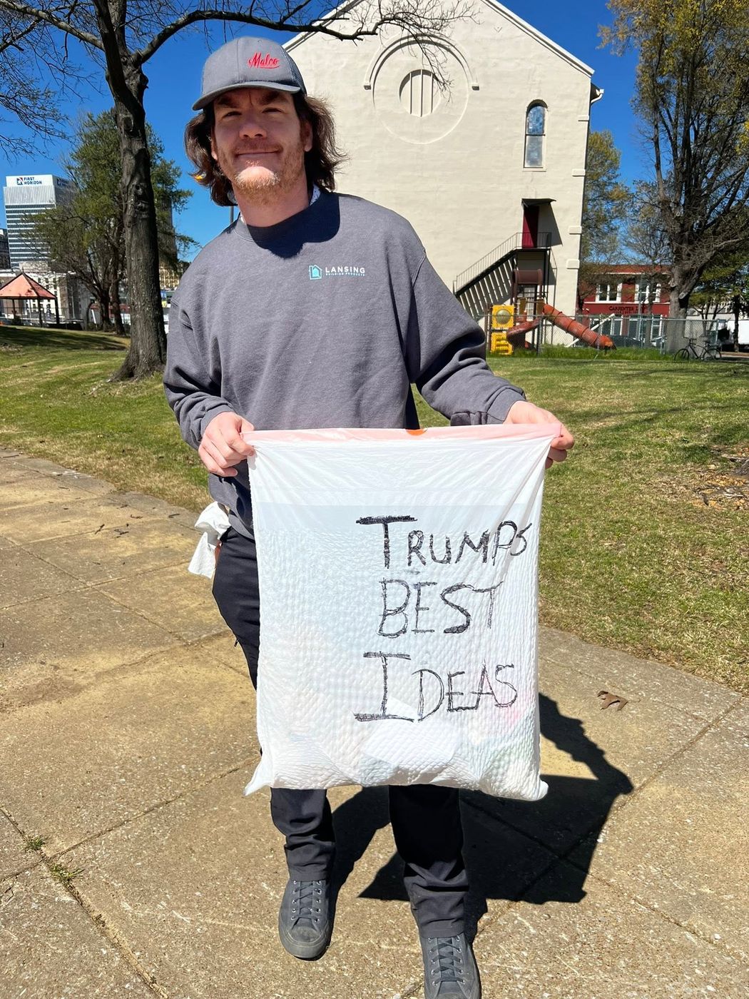 A member holding a hand-lettered sign at an outdoor rally in Memphis.